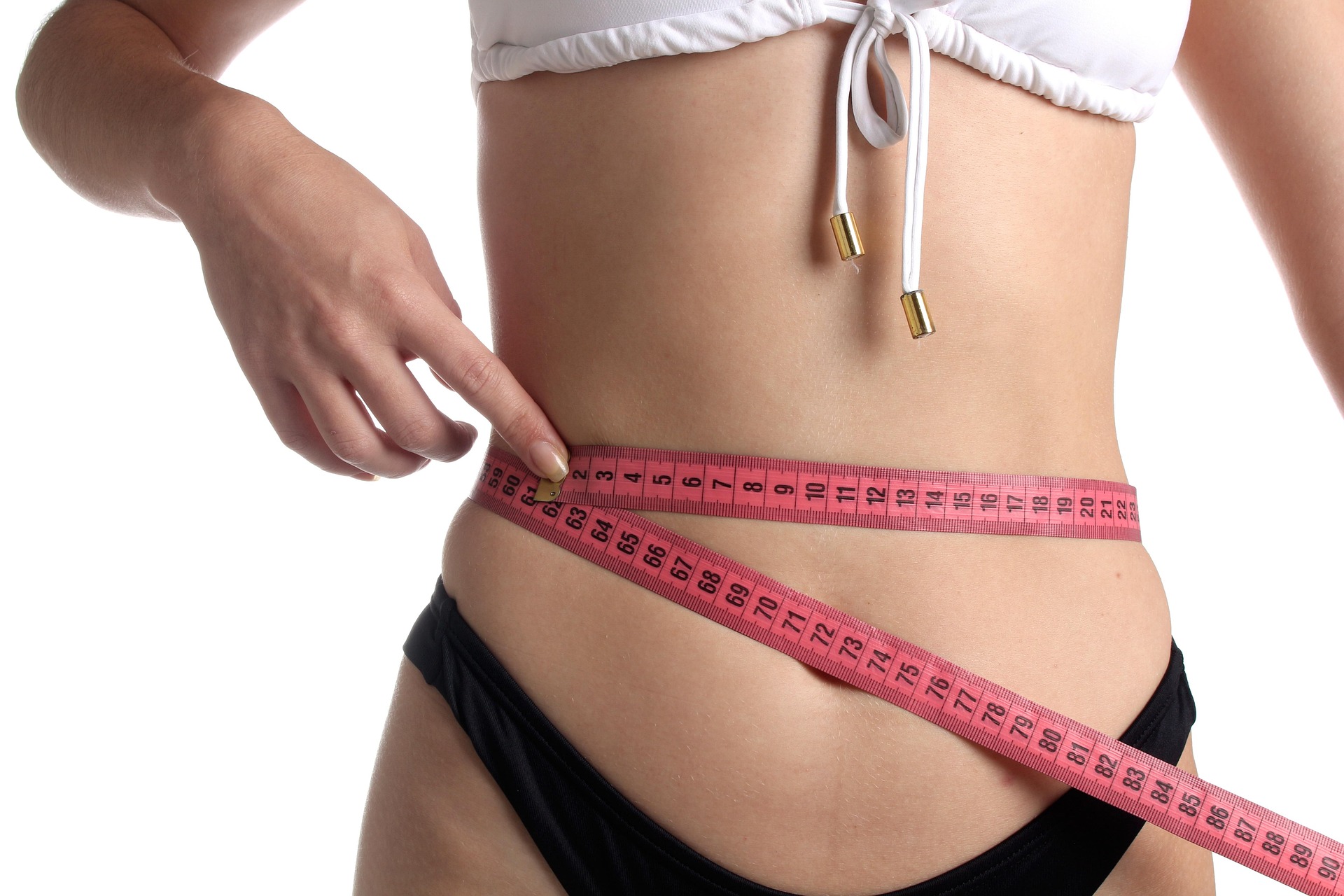 Woman checking weight loss progress on weighing scale